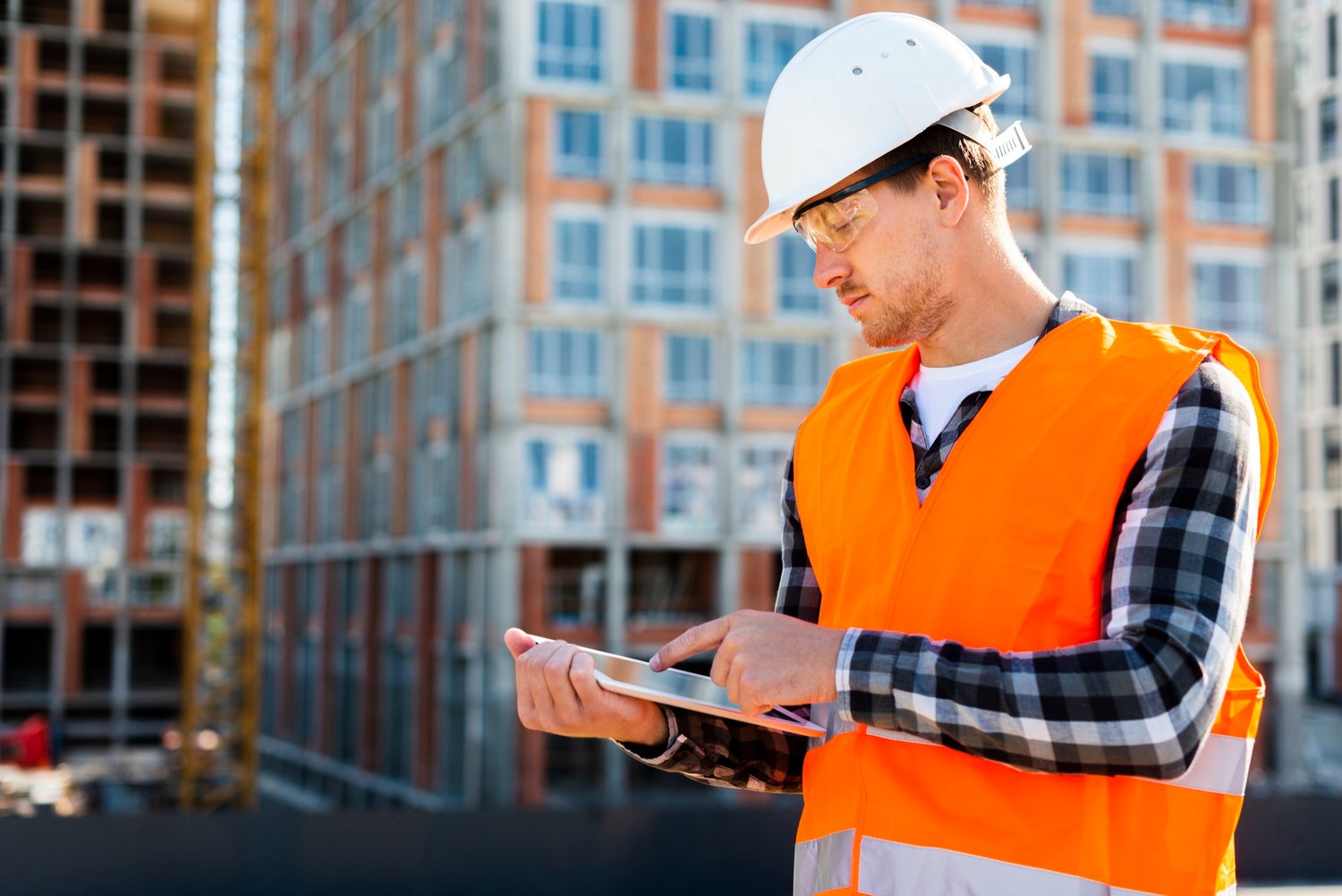 medium-shot-side-view-construction-engineer-using-tablet